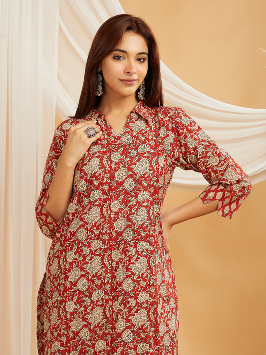 Close-up of red cotton fabric with hand block print details and neckline pattern