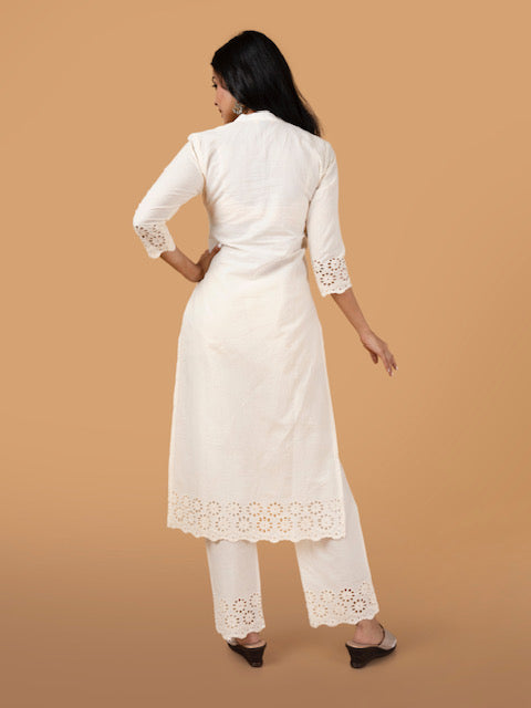 Bak view of women's off- white schiffli cotton kurta with delicate embroidery design.