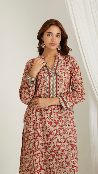 Detailed view of neckline and hand block print pattern on red cotton kurta