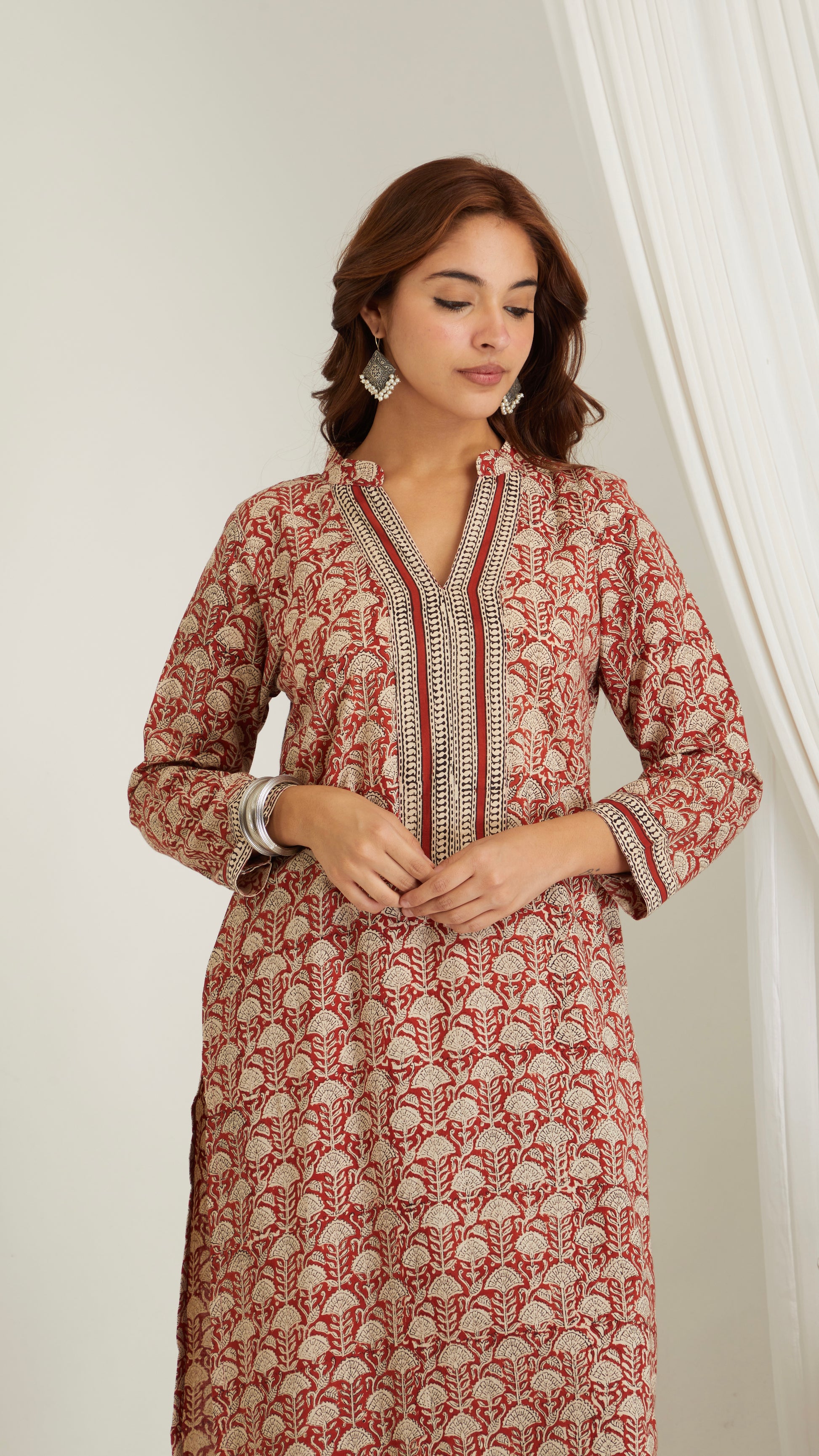 Close-up of red hand block print cotton kurta fabric showing print and texture- close up view